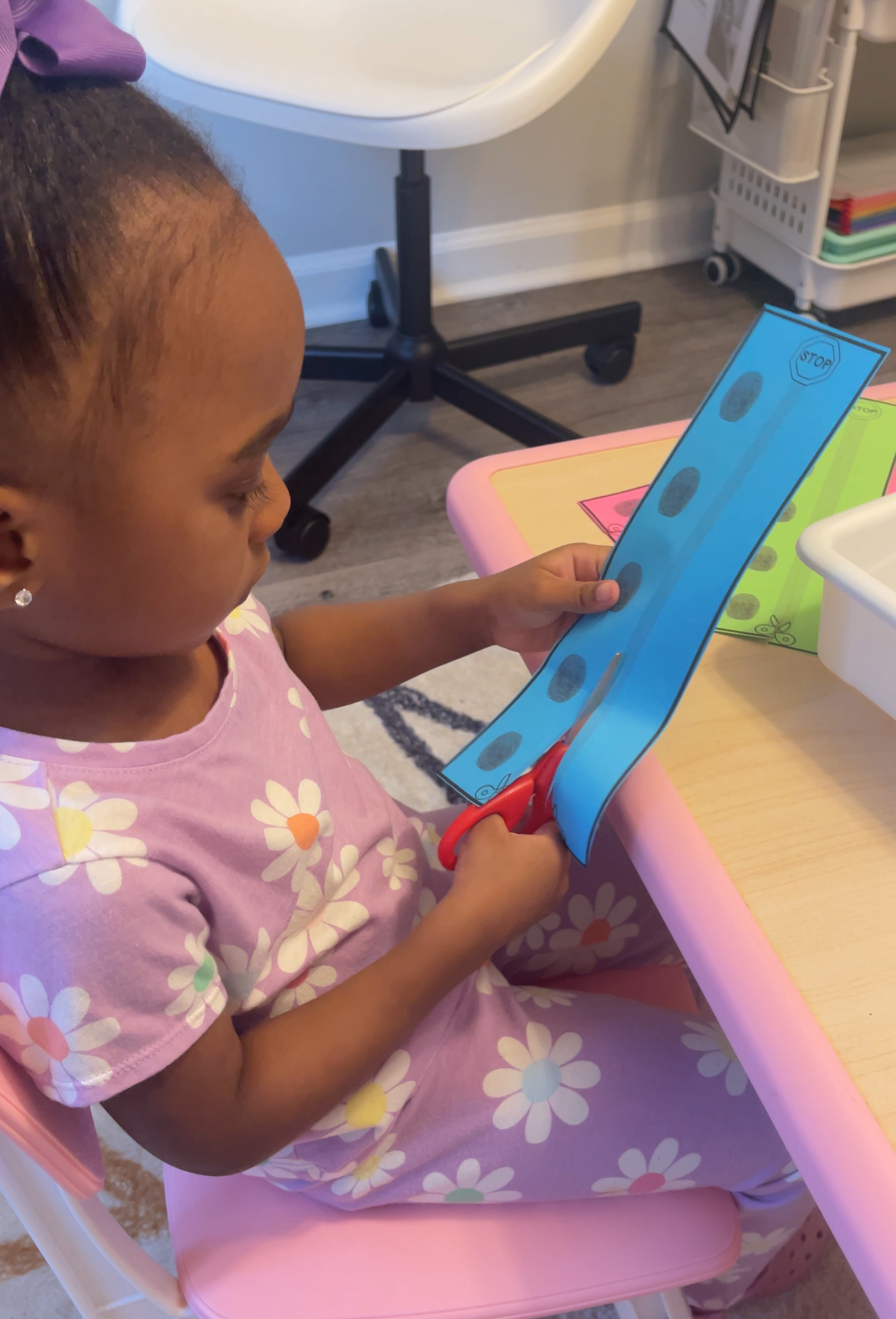 Preschooler cutting with scissors